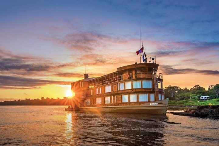 The Delfin II riverboat sails along the Amazon River