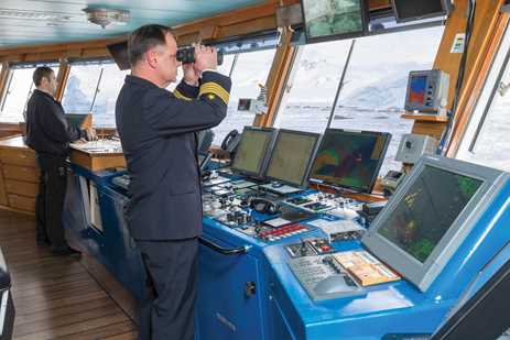 Captain on the Bridge scanning the ocean
