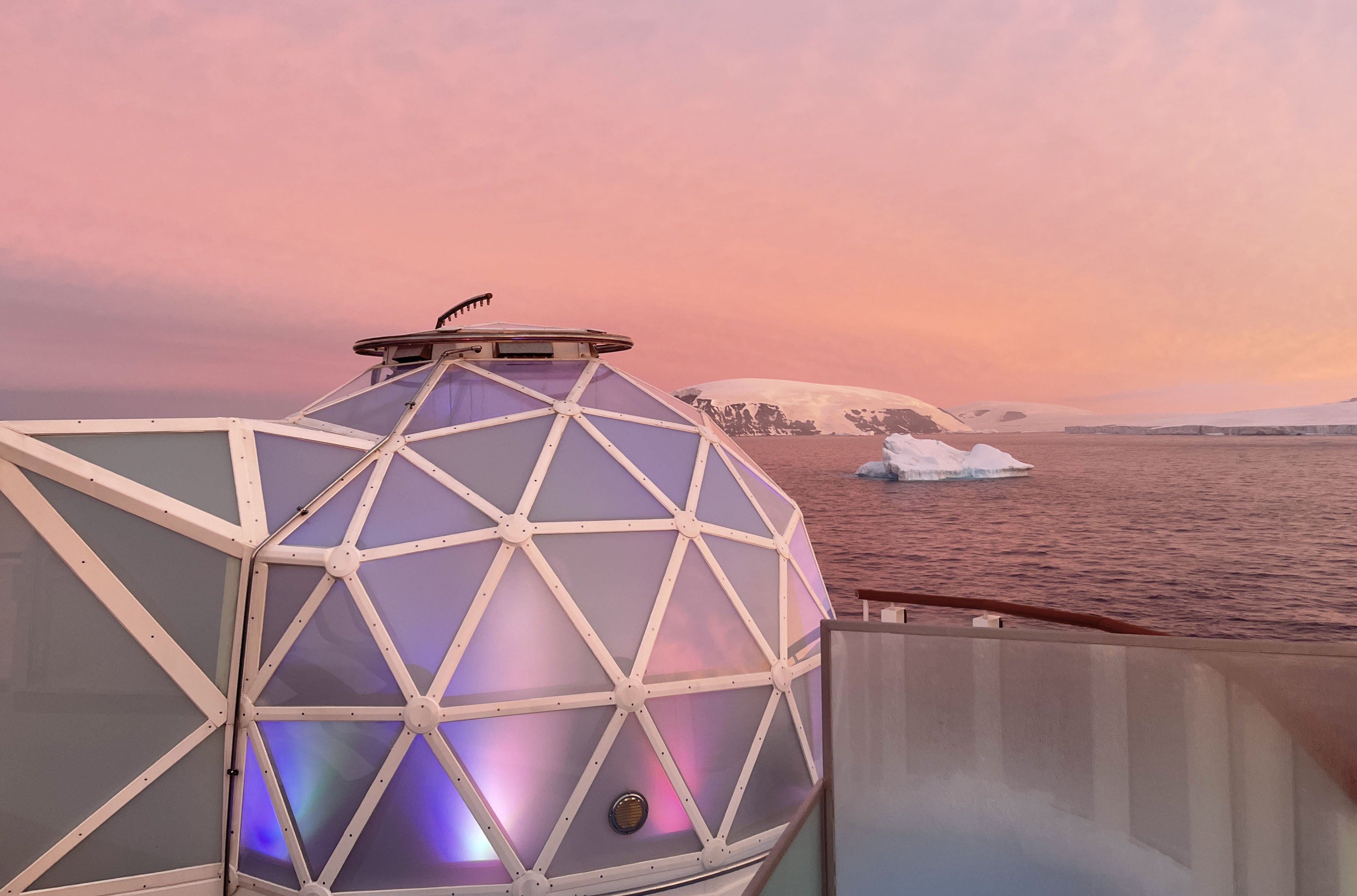 Geodesic glass igloo overlooks Antarctic landscape
