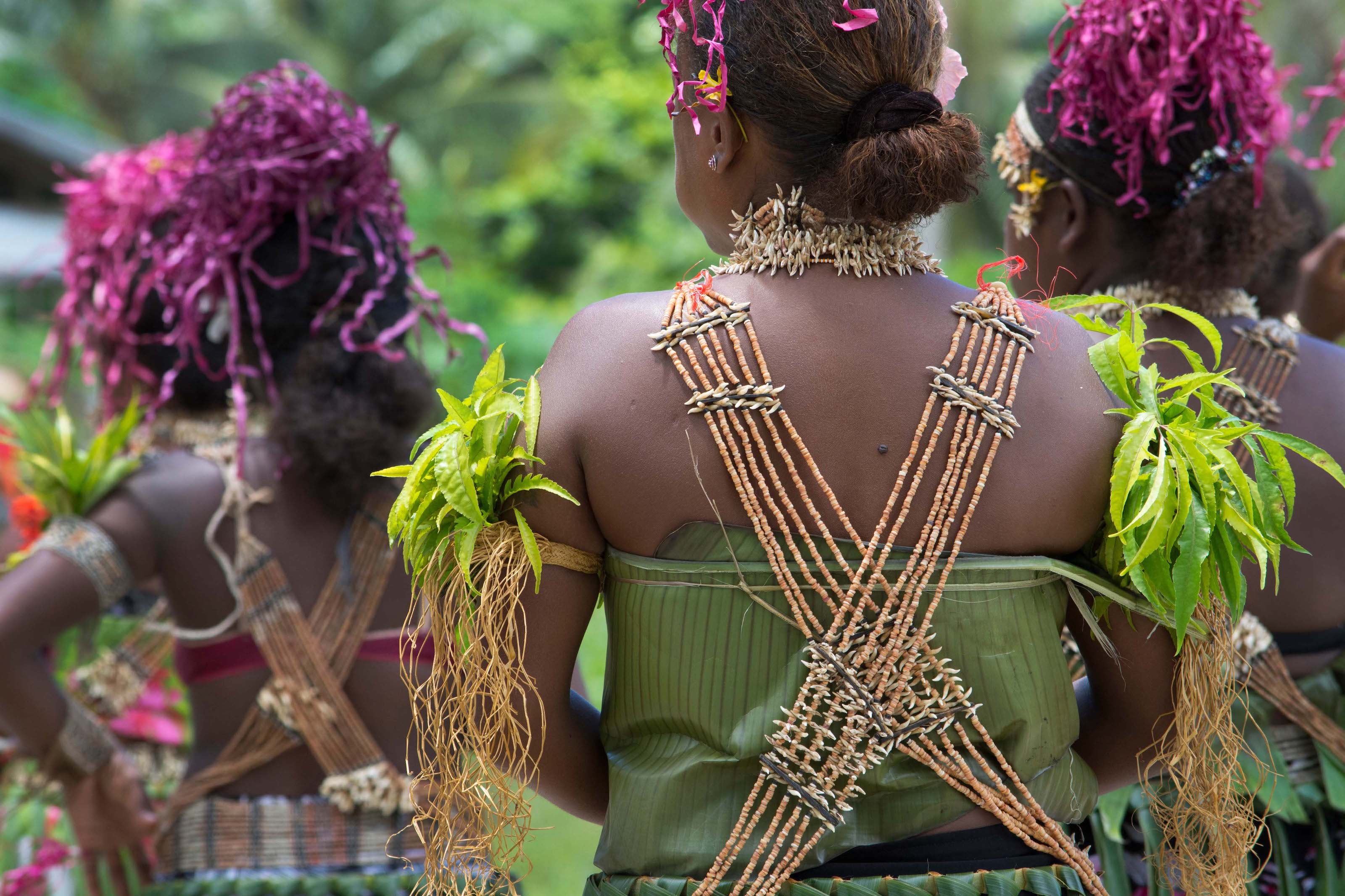 Women in traditional garb perform in the Solomon Islands